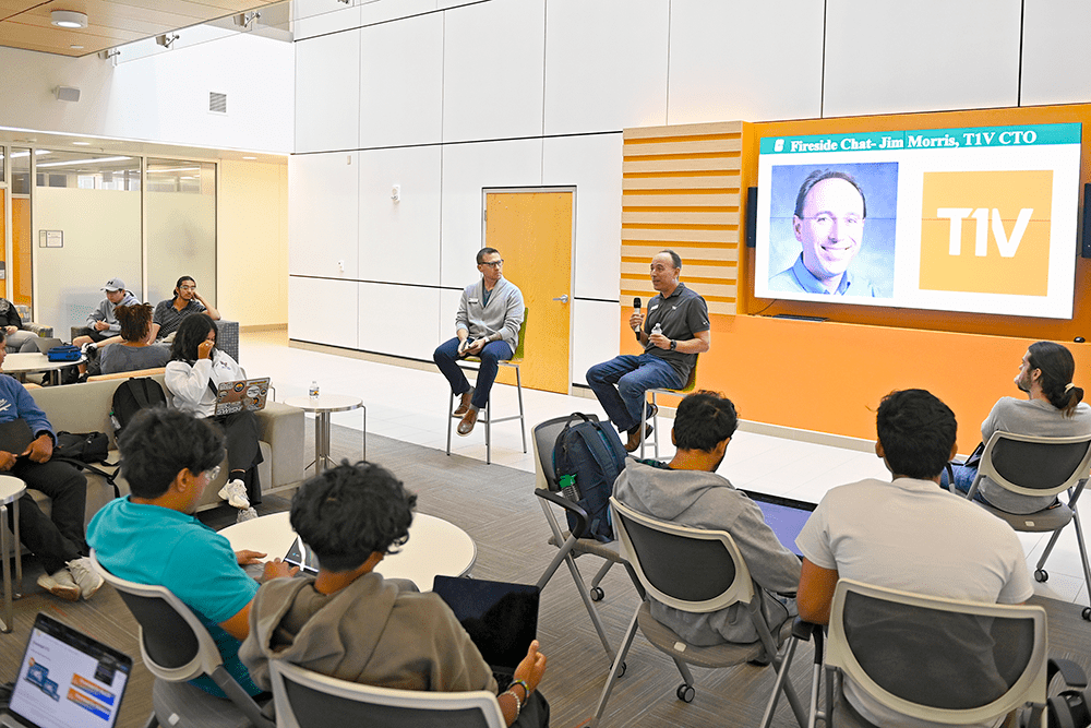 Dr. Brad Yeckley, CEI director, chats with Jim Morris, CTO of T1V, and students in the PORTAL building.
